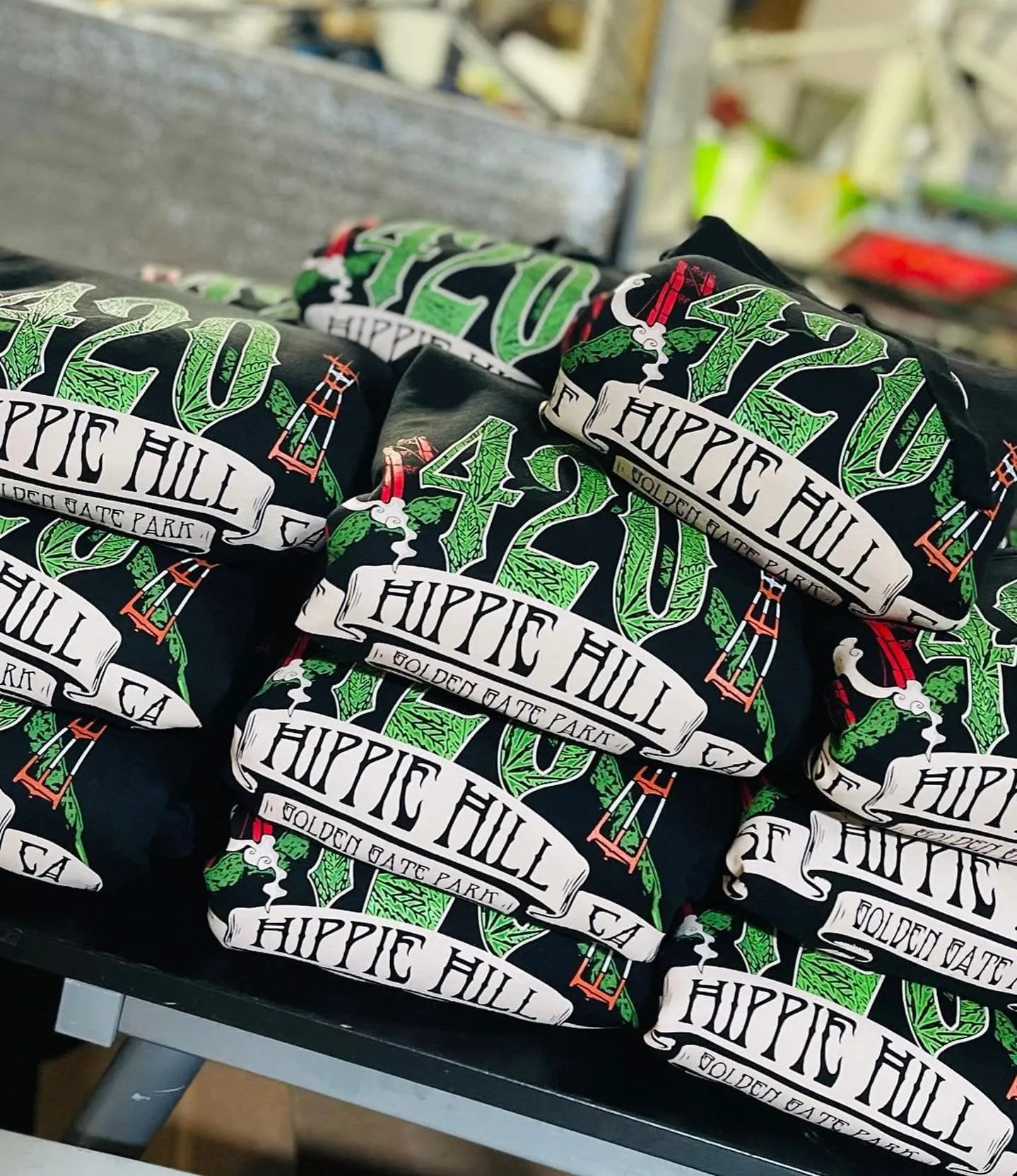 Hippie Hill shirts stacked on table